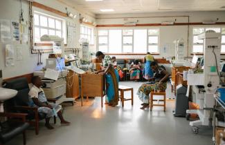 Women attend to their infants in the hospital.