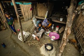 A man and woman cooking a meal.