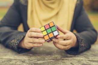 Amani plays with a Rubik’s Cube.