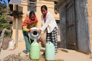 Sangita and her sister-in-law are working to fill the water pots at their home in Pokharikanda. Many households in her village used to spend hours each day fetching water. Now they have a solar-lifting water supply and sanitation system thanks to the USAID Karnali Water Activity and its partnership with the local government. 