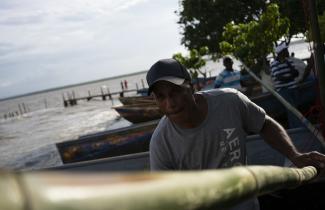 A man holding a long bamboo pole