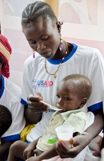 A Burkinabe woman feeds her child