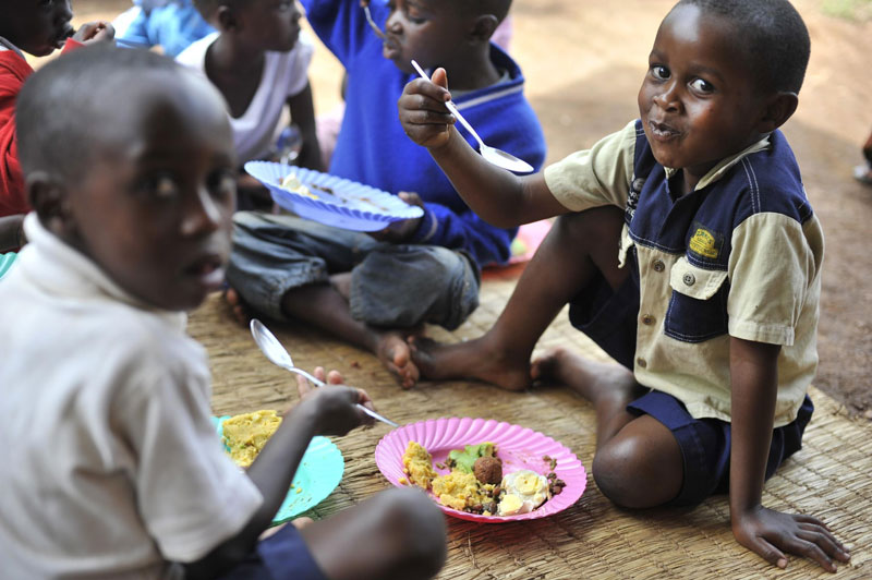 Boys eating on the floor from plates