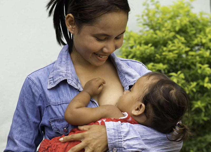 A mother breastfeeds her baby.