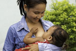 
 A mother breastfeeds her baby.