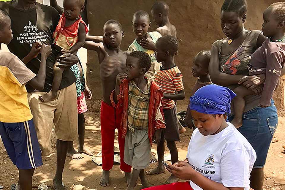 Constance, a member of a trachoma survey team, enters household data into a smartphone through Tropical Data in the Imvepi Refugee Settlement in Uganda.