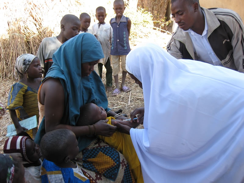 Photo of a family in Cote d'Ivoire getting tested for measles.