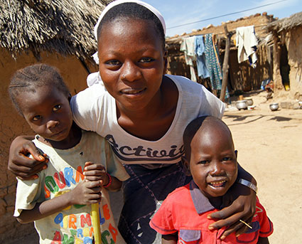 A store owner in Nigeria shows a malaria prevention flyer.