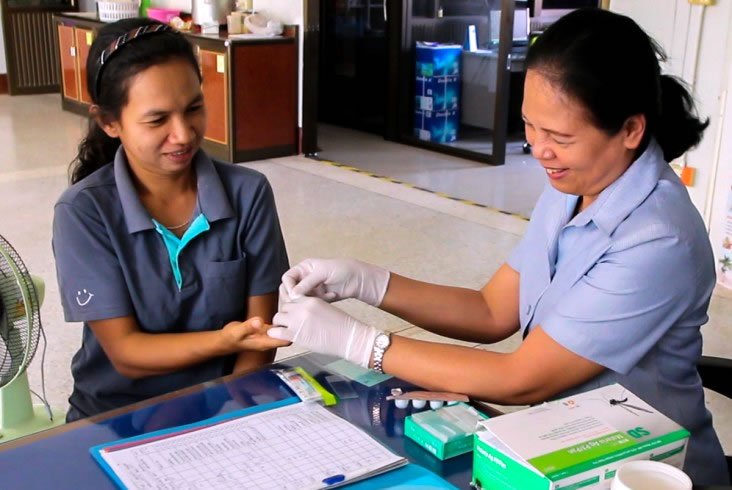 Kanyarat Lausatianragit collects blood for malaria testing. Photo Credit: Sisaket Provincial Public Health Department