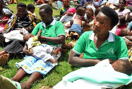 Women in the Bulambira community of Uganda participate in a breastfeeding attachment competition as part of a family life school meeting. Photo: Kate Consavage/USAID