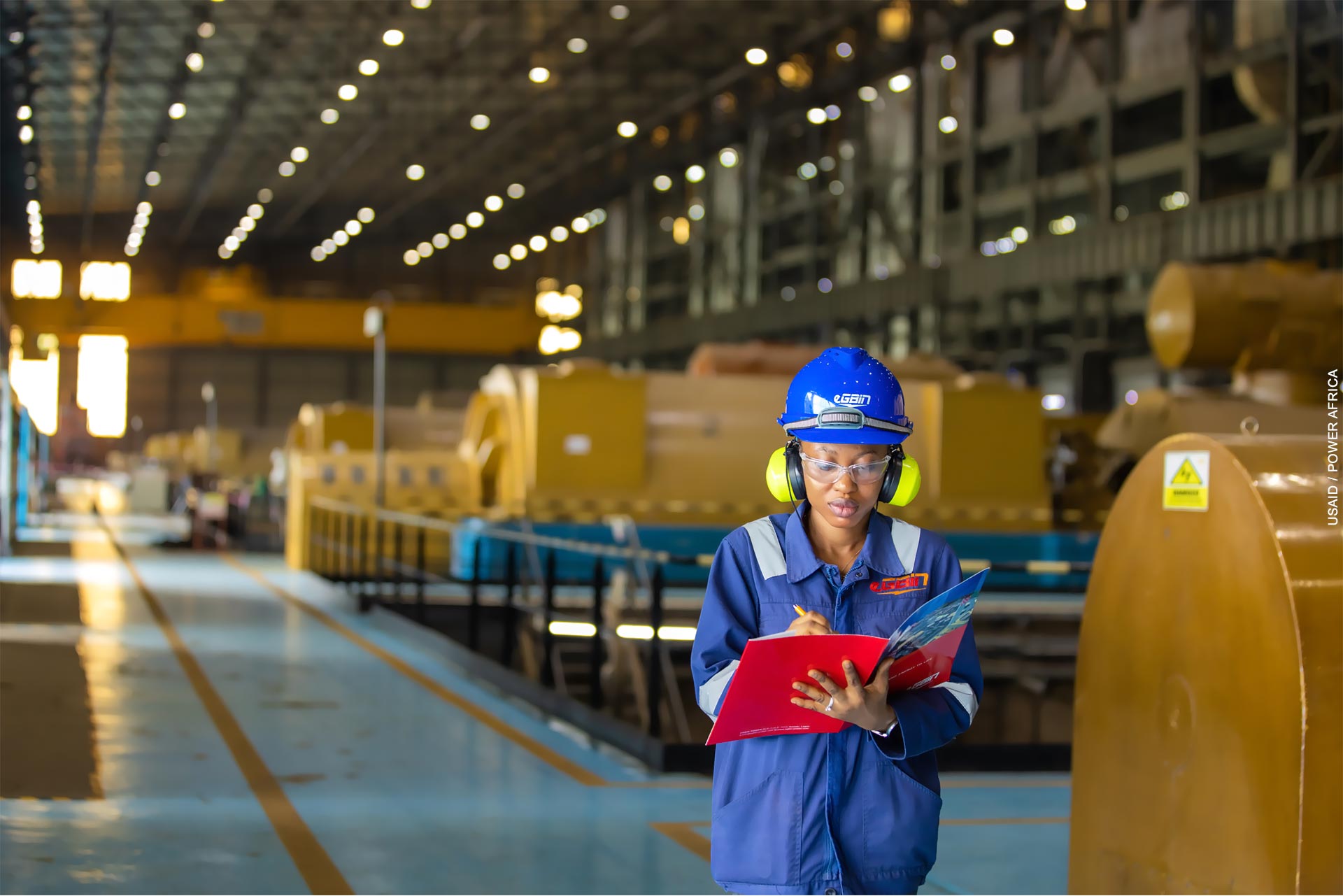 A female Egbin Power engineer performs an equipment check in the generation station