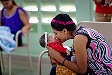 A mother kisses her baby