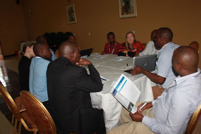 Share Fair attendees discuss the value of developmental evaluation. Photo credit: Coordinating Implementation Research to Communicate Learning and Evidence.